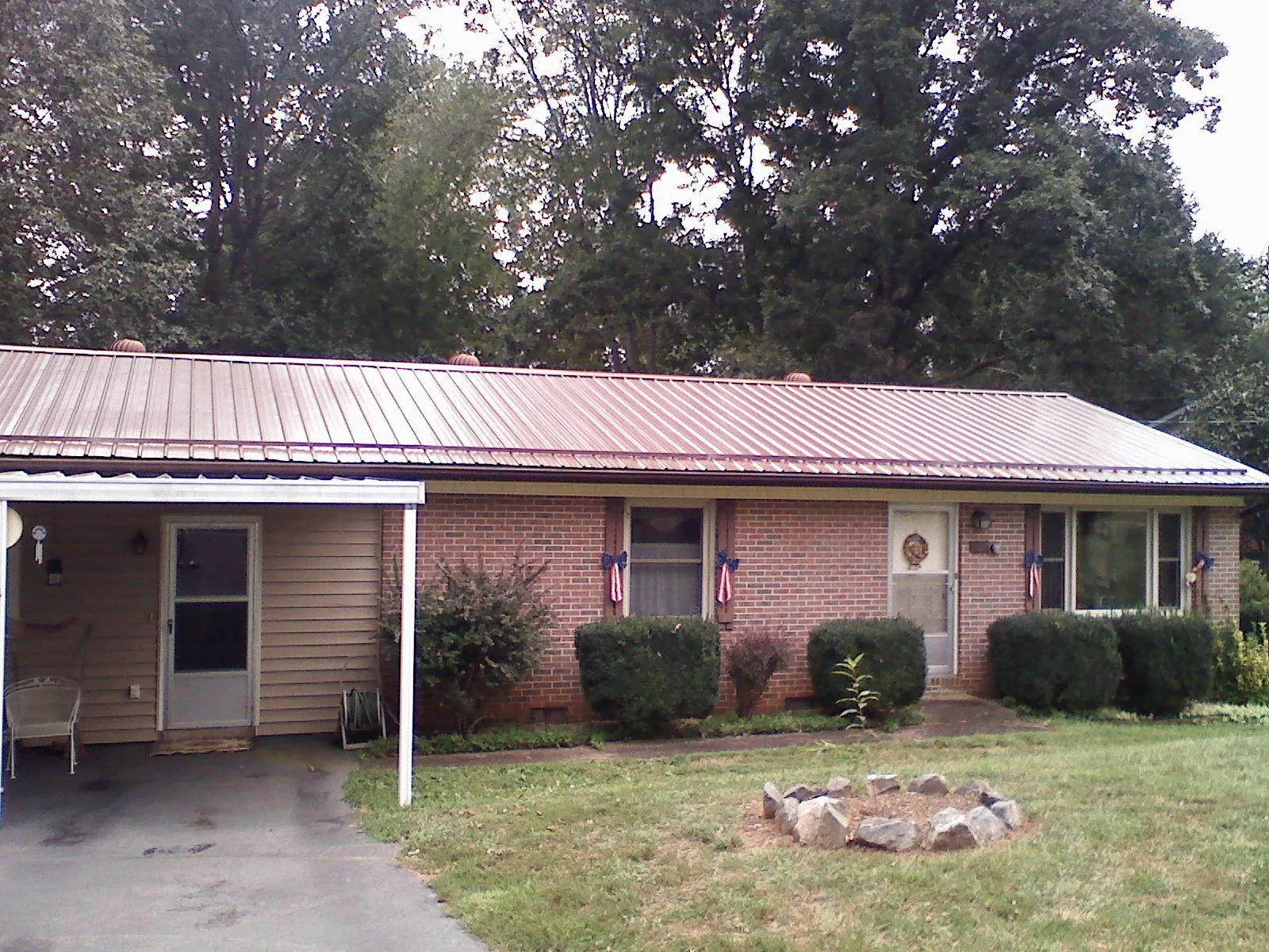Bronze metal roof and carport on a brick ranch home — Roof Repair work by our crew in Andreas