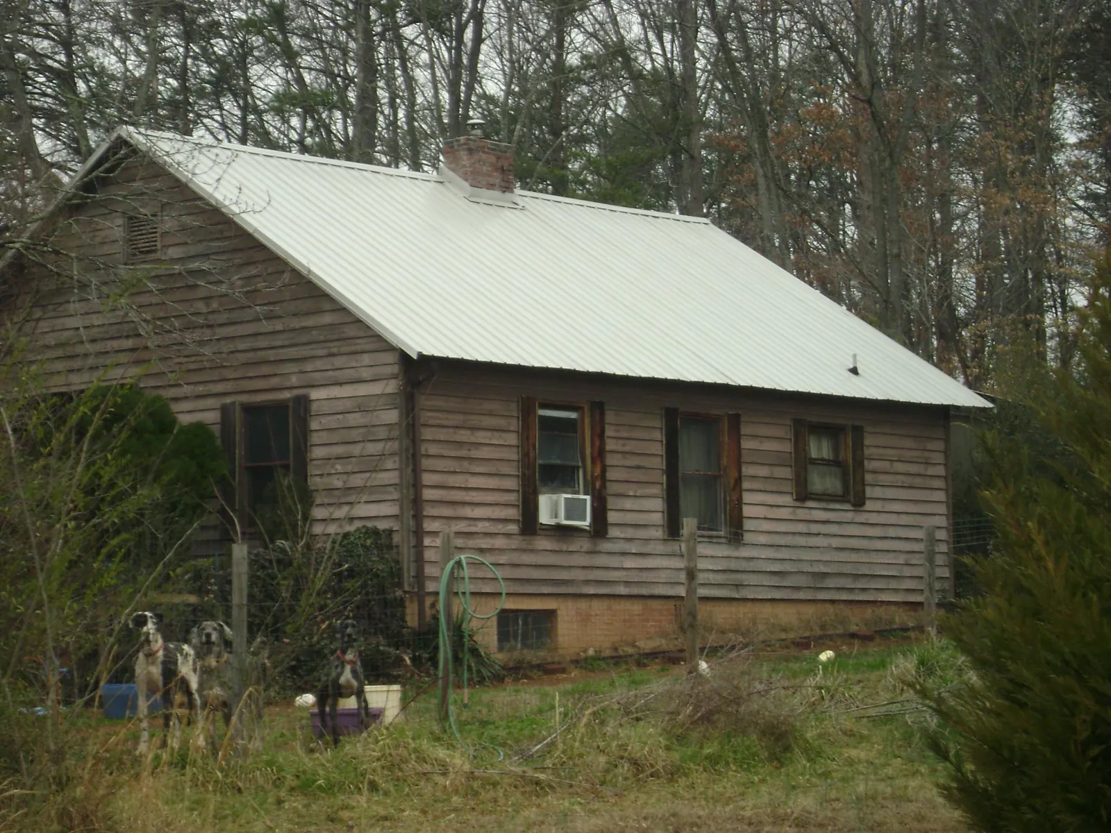 White metal roof on an old wood sided farmhouse, from a Metal Roof Installation job in Andreas